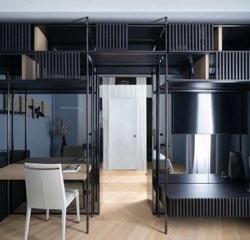 a black bunk bed with a table and a white chair at Interno Marche Design Experience Hotel in Tolentino