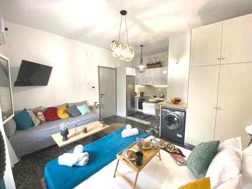 a living room with a couch and a table at Artzy petit apartment close to the center in Heraklio Town