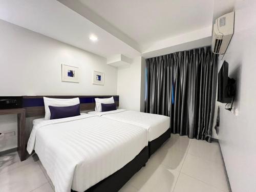 a bedroom with a large bed and a window at Cubic Pratunam in Bangkok