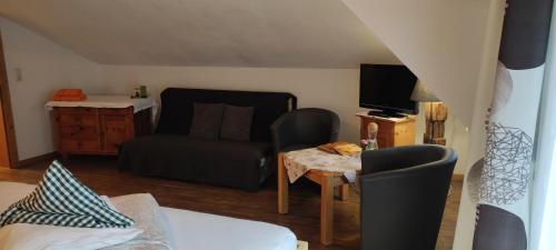 a living room with a couch and a table at Pension Fürhapter mit Bio- Bauernhof in Sankt Jakob in Defereggen