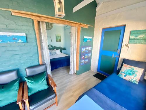 a room with a couch and a bed and a window at Agulhasbestview in Agulhas