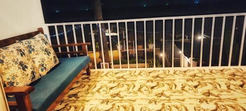 a room with a couch and a balcony with a view at The Village Agonda in Agonda