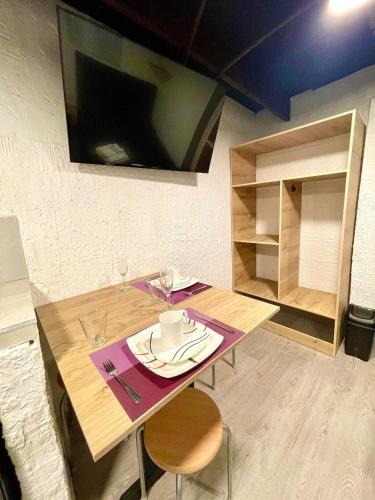 a dining room table with a plate and fork and knife at Súper Apartamento central en Casa Colonial Bogotá in Bogotá