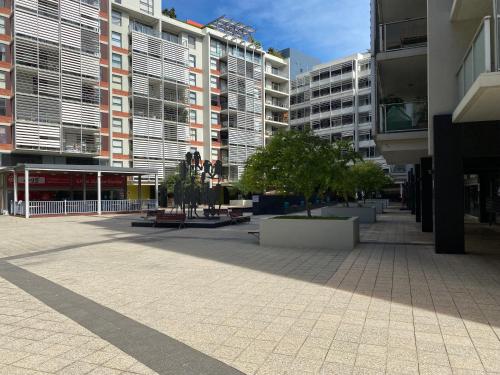 a courtyard in a city with tall buildings at Broadways Best in Sydney