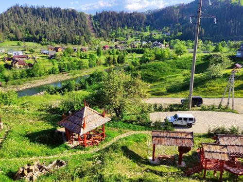 a small village in the mountains with a car parked at Шале Гірська Казка in Yaremche