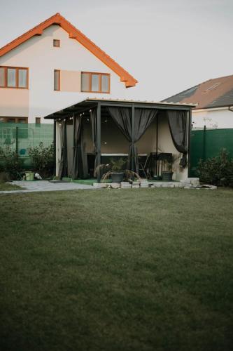 a house with its front door open in a yard at Casa Abiiani in Oradea