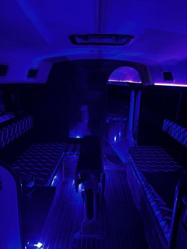 a dark room with two seats in a limo at Star Guide AION in Izola