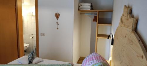 a small room with a bed and a bathroom at Pension Fürhapter mit Bio- Bauernhof in Sankt Jakob in Defereggen