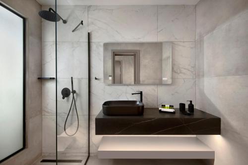 a bathroom with a sink and a shower at Urban Habitat Executive Suites in Nicosia