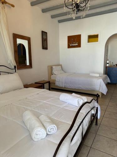 a bedroom with two beds with towels on them at Harry’s studio in Naousa