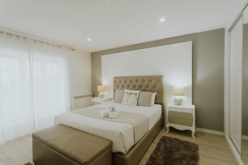 a bedroom with a large bed with a large window at Best Houses 107 - Ferrel Village House in Ferrel