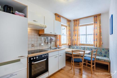 a kitchen with a table and chairs and a dining room at Appartment Venter Bergwelt in Vent