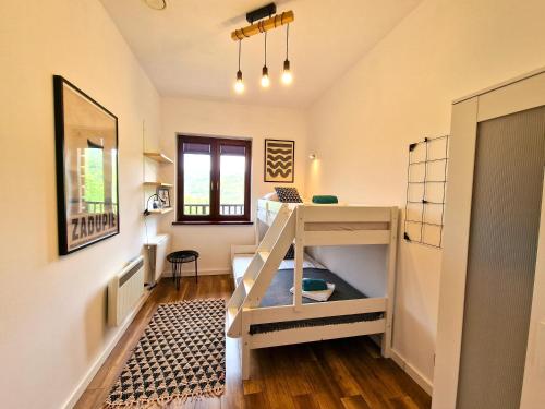 a bunk bed in a room with a desk at Bojkowa Chata in Smerek