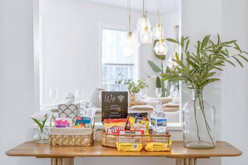 a table with food and a vase on it at Boho Haven Hideaway - Walk to Pool,Theater,Arcades, Firepit, Lake Access in Thornhurst