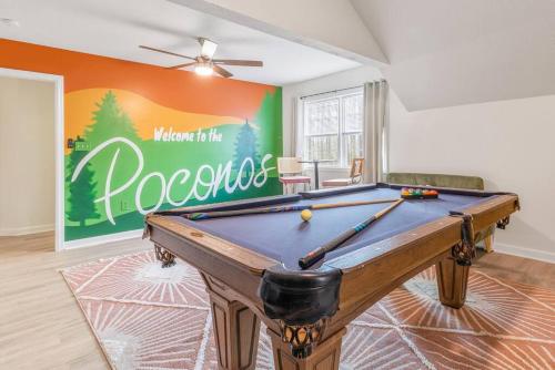 a pool table in a room with a sign at Boho Haven Hideaway - Walk to Pool,Theater,Arcades, Firepit, Lake Access in Thornhurst