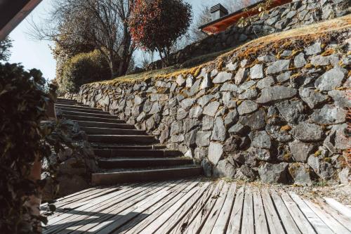 a stone wall and stairs next to a sidewalk at Marinas Alto Manzano in Villa La Angostura