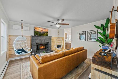 a living room with a couch and a fireplace at Boho Haven Hideaway - Walk to Pool,Theater,Arcades, Firepit, Lake Access in Thornhurst