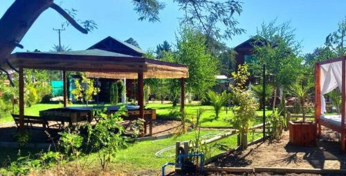 a garden with a pavilion in a park at Cabañas con Tinaja 4 a 6 personas in Quillón
