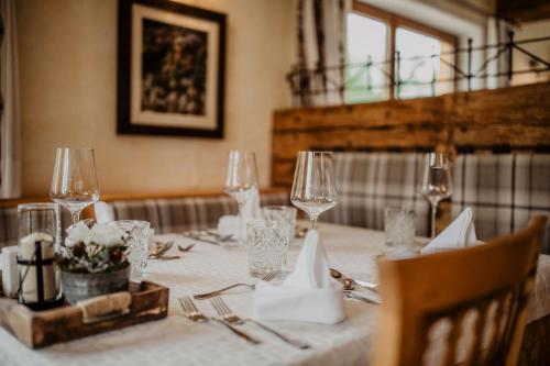 a table with wine glasses and napkins on it at Hotel loj - our kind of place in Flachau