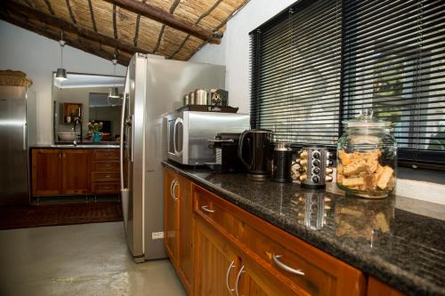 a kitchen with a refrigerator and a counter top at Grootvallei Guest Farm - Main lodge in Boshof
