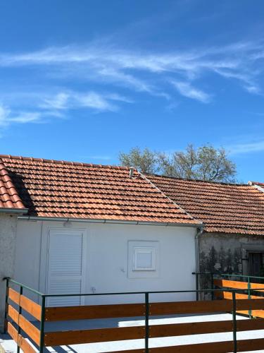 a white building with a fence in front of it at The Nook in Bilice