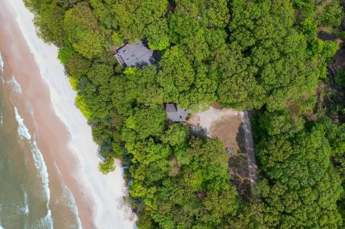 an overhead view of a beach and the ocean at Gebhard Chalet - Charming, private, beachfront chalet nestled in a wooded dune on Lake Michigan in Coloma
