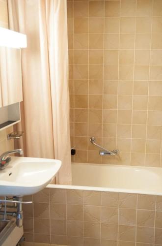 a bathroom with a tub and a sink and a shower at Wunderbarer Panoramablick in Les Collons