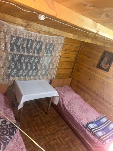 a small room with a bench in a cabin at Гостевой дом ОЛЖАС in Borovoye