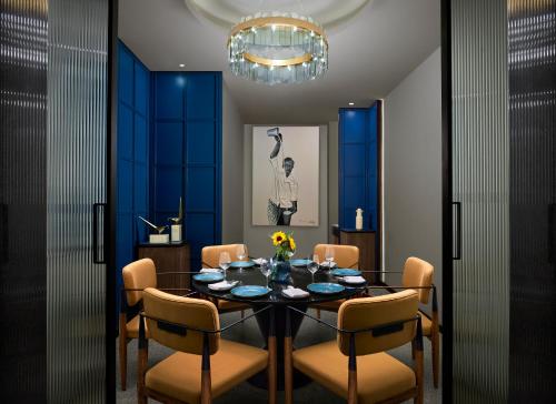 a dining room with a table and chairs at Hyatt Centric Hebbal Bengaluru in Bengaluru