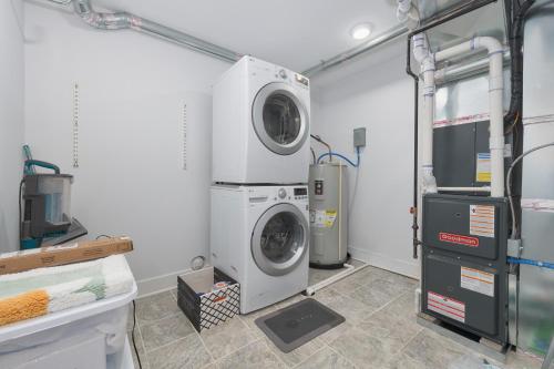 a laundry room with a washer and dryer at Ground Floor Getaway- Year round pool and hot tub in South Haven