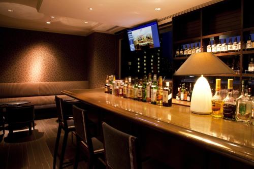 a bar with a lot of bottles of alcohol at Okura Chiba Hotel in Chiba