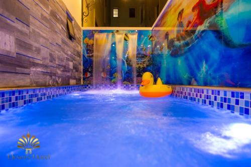a swimming pool with a rubber duck in the water at Elysees Sam Son Beach Hotel in Thanh Hóa