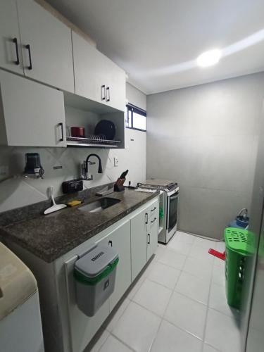 a kitchen with a sink and a counter top at Praia do Bessa, Caribessa - Quarto Privativo - Conforto, Paz e Sossego, excelente para descansar, trabalhar ou estudar in João Pessoa