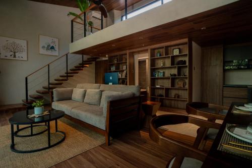ein Wohnzimmer mit einem Sofa und einer Treppe in der Unterkunft Piece Lio Resort from Japan in El Nido