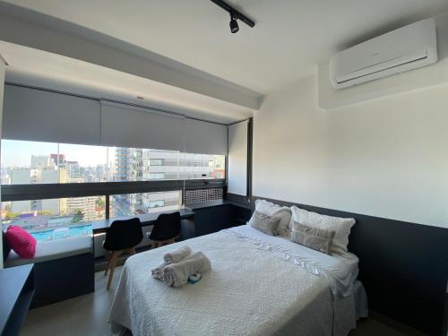 a bedroom with a bed with a stuffed animal on it at Studio Oscar Freire, linda vista de SP!1716 in Sao Paulo