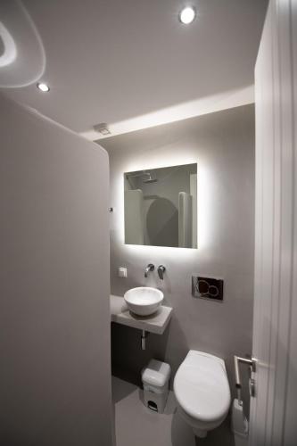 a bathroom with a white toilet and a sink at Lilian Beach Front 3 Skopelos in Panormos Skopelos