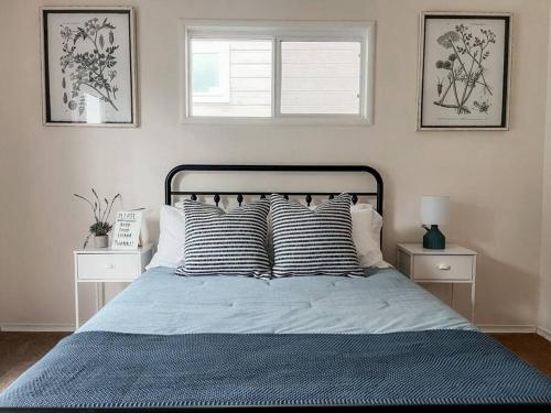 a bedroom with a bed with blue sheets and pillows at Beautiful Coast Home 3 Minutes From Beach! in Bodega Bay