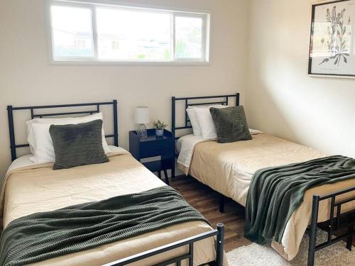 a bedroom with two beds and a window at Beautiful Coast Home 3 Minutes From Beach! in Bodega Bay