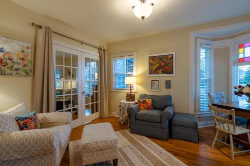 a living room with a couch and a table at For Pete's Sake - private pickleball court & 2 blocks to beach! in South Haven