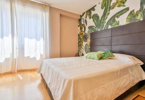 a bedroom with a large bed and a large window at Villa Santa Maria - Luxury Suites in Amalfi