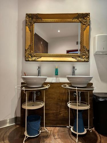 a bathroom with two sinks and a mirror at Aldeamento Turístico do Camarido, Nature & Beach Resort in Caminha