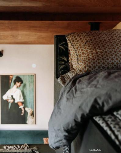 a bedroom with a bed with a picture on the wall at Deborah's Hiding Place in Alkmaar