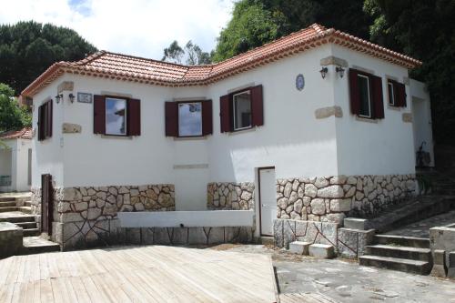 a white house with a stone wall at Senhora da Paz Lisboa Sintra in Sintra