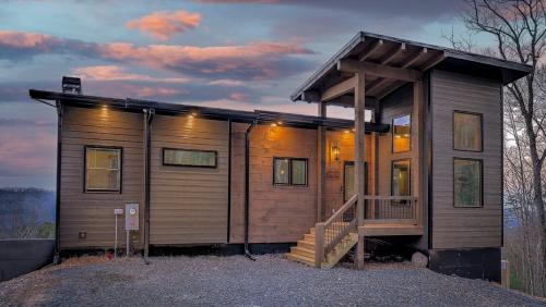 a small wooden house with a porch and a staircase at Boundless Views in Mashburn Mill