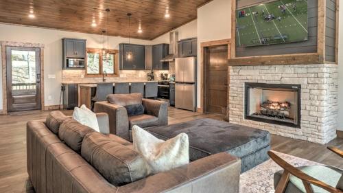 a living room with a couch and a fireplace at Boundless Views in Mashburn Mill