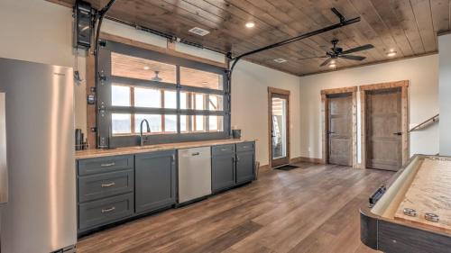 a large kitchen with a sink and a refrigerator at Boundless Views in Mashburn Mill