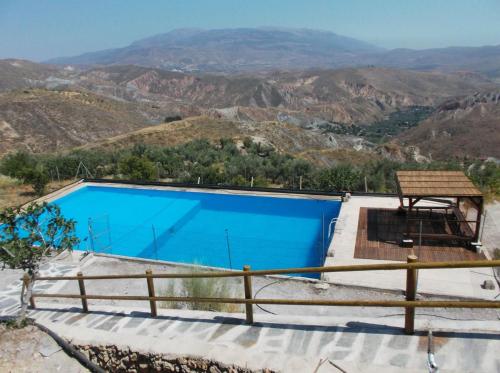 a swimming pool with a view of the mountains at VIVIENDASFUENTEZUELAS in Laroles