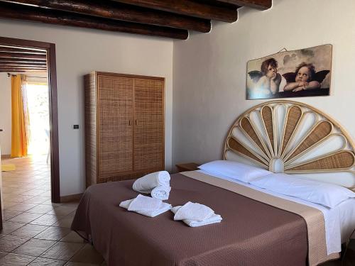 a bedroom with two beds with towels on them at Residence Villa Felice in Lampedusa