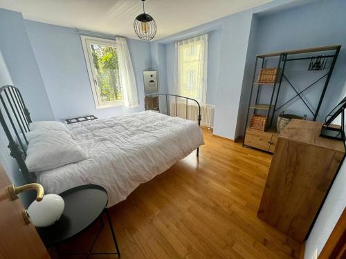 a bedroom with a bed and a wooden floor at Casa Lilia in Lugano