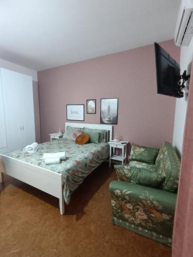 a bedroom with a bed and a couch at B&B Le Coccole di Galluzzo Gabriele in Aragona